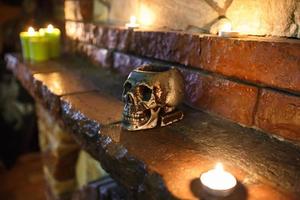 Skull lying on the fireplace of an ancient castle photo