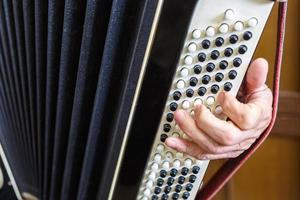 Musician hand playing accordions closeup photo