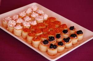 Assorted appetizers, pastries with three different filling, salmon and cheese, majorcan sobrasada and caviar photo