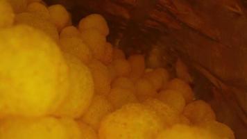 Macro view of the crispy thin potato snack chips, fast food snacks. View from the inside of the package. Snacks in a package close-up. video