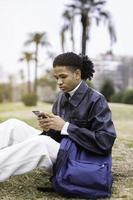 Young african-american man with a mobile phone photo
