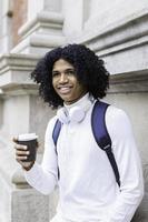 Portrait of a happy african american holding coffee photo