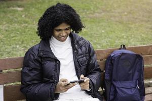 Young boy playing mobile phone photo