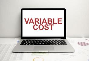 variable cost words on display laptop and charts photo