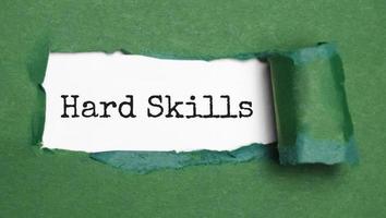 the word hard skills appearing behind torn white paper, photo