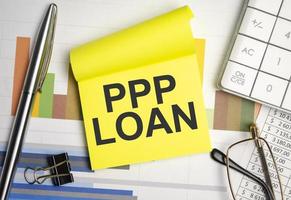 yellow sticker with the text ppp loan and charts photo