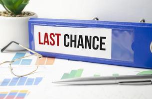 last chance words on blue file folder and charts photo