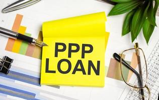 yellow sticker with the text ppp loan and charts photo