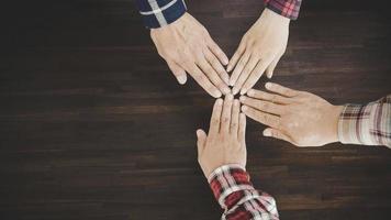 young business people putting their hands together photo