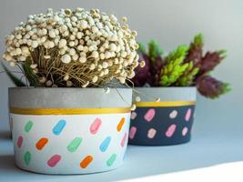 Colorful round geometric planters. Painted concrete pots for home decoration photo