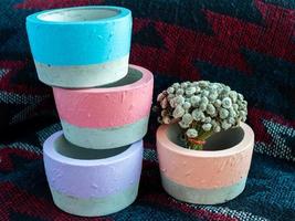 Colorful round geometric planters. Painted concrete pots for home decoration photo