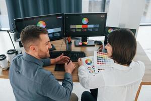 Creative occupation. Two designers working together in the office photo