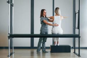 Working with arms. Woman is in health center getting help by doctor photo