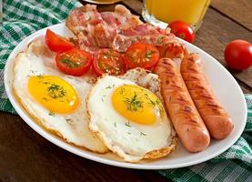 English breakfast - toast, egg, bacon and vegetables in a rustic style on wooden background photo