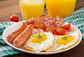 English breakfast - toast, egg, bacon and vegetables in a rustic style on wooden background photo