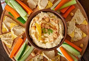 Healthy homemade  hummus with olive oil and pita chips photo