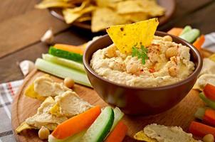 Healthy homemade  hummus with olive oil and pita chips photo