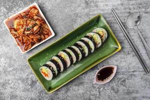 Top view Korean food, Gimbap or Kimbap is seaweed rice roll and kimchi side dish. photo