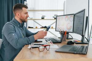 Using different colors. Male designer working in the office by using PC photo