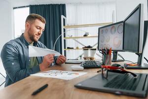 Creative occupation. Male designer working in the office by using PC photo