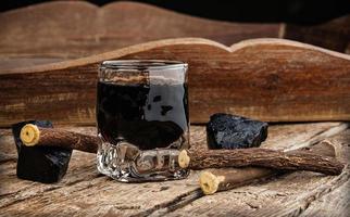 Licorice liqueur with pure blocks and roots. photo