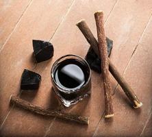Licorice liqueur with pure blocks and roots. photo