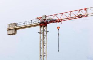 Red and white  hoisting crane photo