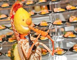 Decoration made with lobster, lemon and carrot. photo