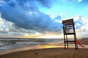 Landscape of beach with the wooden lookout tower photo