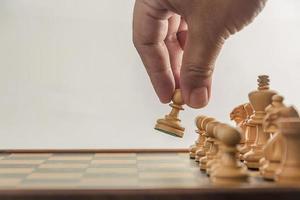 Chess on board with hand , white background photo