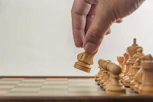 Chess on board with hand , white background photo