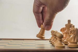 Chess on board with hand , white background photo
