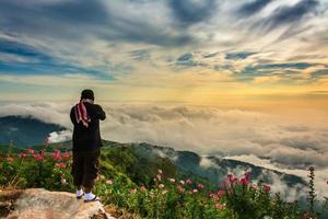 The tourist with Morning Mist with Mountain ,sea of mis photo