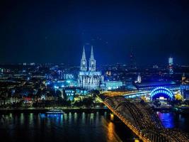 HDR Aerial night view of St Peter Cathedral and Hohenzollern Bri photo