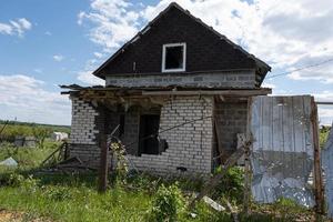 KHARKIV, UKRAINE - May, 04, 2022. War in Ukraine. Destroyed, bombed and burned residential building after Russian missiles in Kharkiv countryside Ukraine. Selective focus. Russian attack on Ukraine. photo