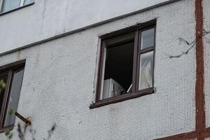 KHARKIV, UKRAINE - May, 04, 2022. War in Ukraine 2022. Destroyed, bombed and burned residential building after Russian missiles in Kharkiv Ukraine. Broken window. Russian attack on Ukraine. photo