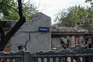 KHARKIV, UKRAINE - May, 04, 2022. War in Ukraine 2022. Destroyed, bombed and burned residential building after Russian missiles in Kharkiv countryside Ukraine. Russian attack on Ukraine. photo