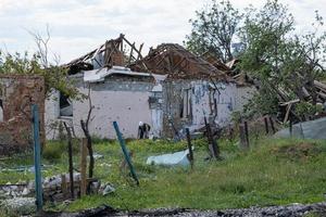 KHARKIV, UKRAINE - May, 04, 2022. War in Ukraine 2022. Destroyed, bombed and burned residential building after Russian missiles in Kharkiv countryside Ukraine. Russian aggression. photo