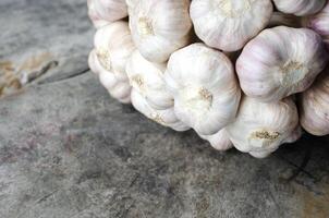 Close up off Garlic vegetable on wooden table for food backgrounds concept photo