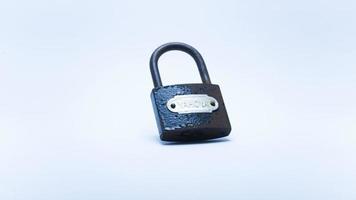 Photo of an old rusty padlock on a white background. Suitable for design element of security, retro background, and safety protection.