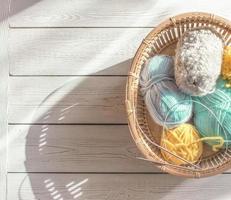 knitting yarn and metal needles ina basket. top view. photo