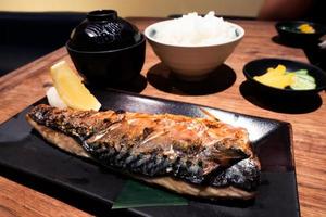 Saba grill set on a wooden table in a Japanese restaurant photo