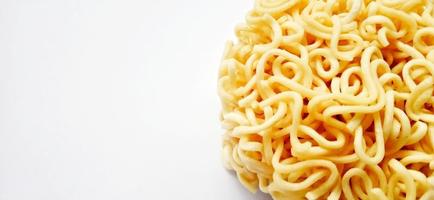 Uncooked instant noodles with negative space isolated on the gray white studio background. Food background design. Suitable for promotion of food and beverage industry and company, food advertising. photo
