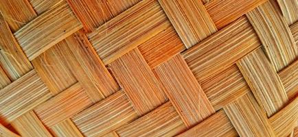 Orange bamboo weave texture or bamboo weave pattern background. Weave texture or weave pattern in classic retro style for design. photo