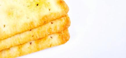 Sugarless and vegetable healthy cracker biscuit slices on the gray white studio background. Food background design. Suitable for promotion of food and beverage industry and company, food advertising. photo