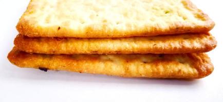 Sugarless and vegetable healthy cracker biscuit slices on the gray white studio background. Food background design. Suitable for promotion of food and beverage industry and company, food advertising. photo