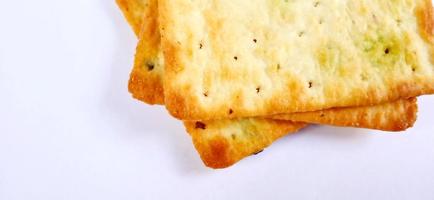 Sugarless and vegetable healthy cracker biscuit slices on the gray white studio background. Food background design. Suitable for promotion of food and beverage industry and company, food advertising. photo