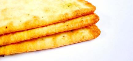 Sugarless and vegetable healthy cracker biscuit slices on the gray white studio background. Food background design. Suitable for promotion of food and beverage industry and company, food advertising. photo