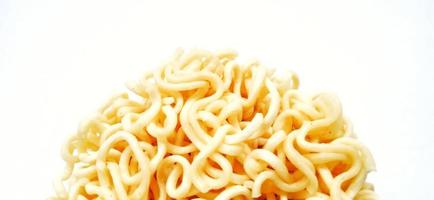 Uncooked instant noodles with negative space isolated on the gray white studio background. Food background design. Suitable for promotion of food and beverage industry and company, food advertising. photo