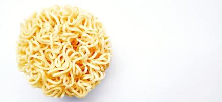 Uncooked instant noodles with negative space isolated on the gray white studio background. Food background design. Suitable for promotion of food and beverage industry and company, food advertising. photo